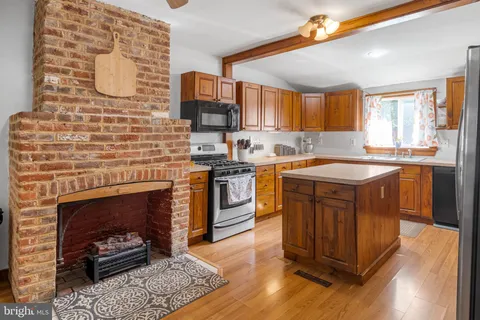 a kitchen with a sink cabinets appliances and a window
