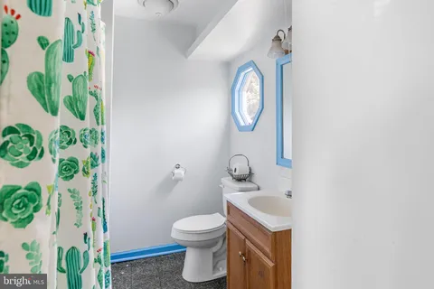 a bathroom with a toilet sink and mirror