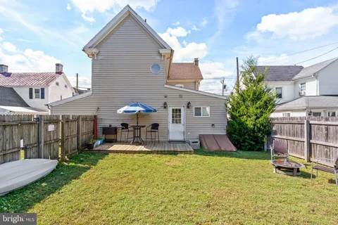 a front view of a house with a yard table and chairs