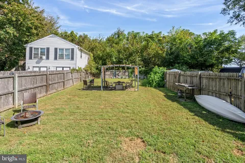 a view of a chairs and table on the wooden deck