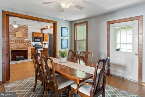 a dining room with furniture window and wooden floor