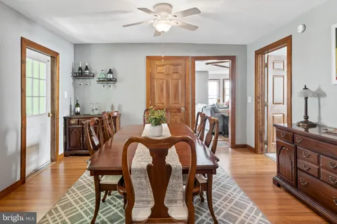 a view of a a dining room with furniture window and wooden floor