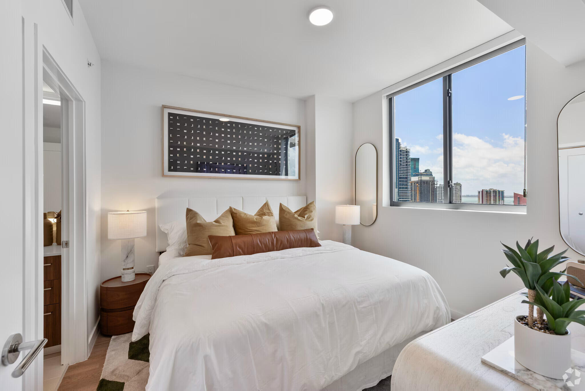 201 Southwest 10th Street, Unit 2201 Miami, FL 33130 - Photo 12 of 17 a bedroom with a large bed and a potted plant