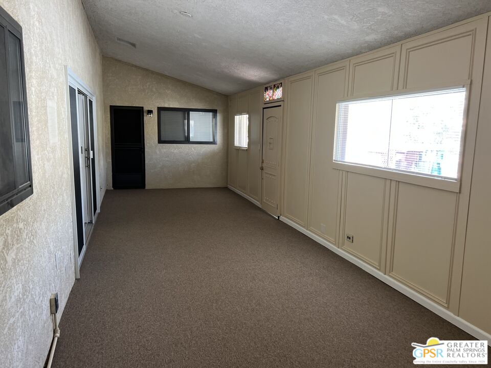 Undisclosed Address Yucca Valley, CA 92284 - Photo 15 of 46 a view of a big room with windows and chandelier