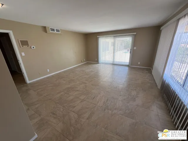 a spacious bathroom with a granite countertop sink a toilet a mirror and vanity