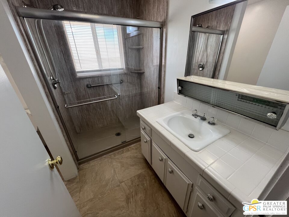 Undisclosed Address Yucca Valley, CA 92284 - Photo 26 of 46 a bathroom with a sink a mirror and shower