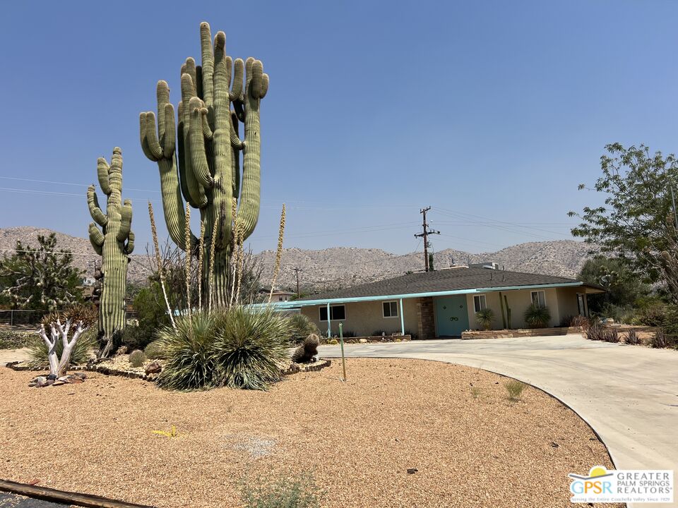 Undisclosed Address Yucca Valley, CA 92284 - Photo 37 of 46 a front view of a house with a yard and garage