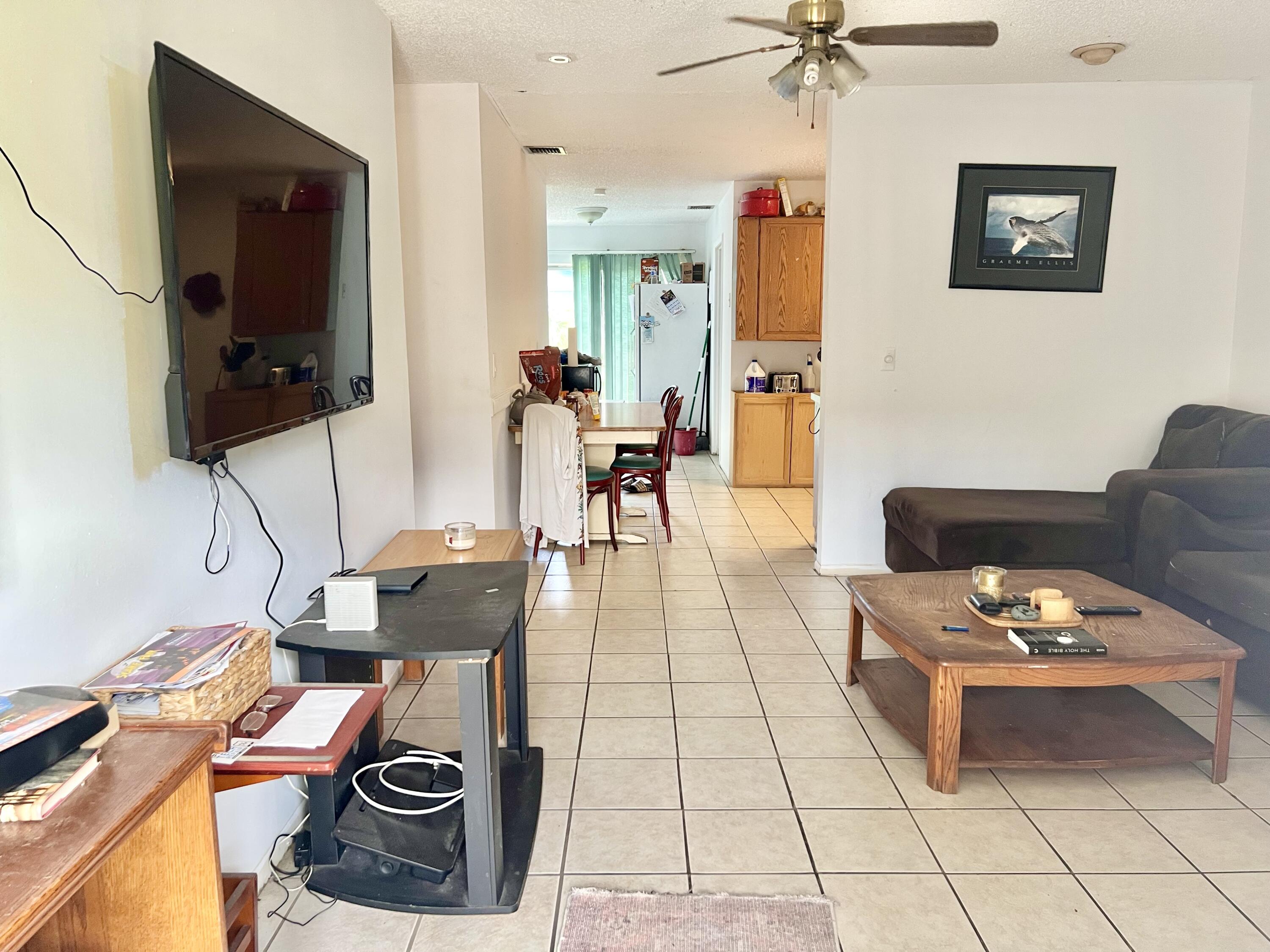 2621 Southeast Clayton Street Stuart, FL 34997 - Photo 13 of 40 a living room with furniture and a flat screen tv