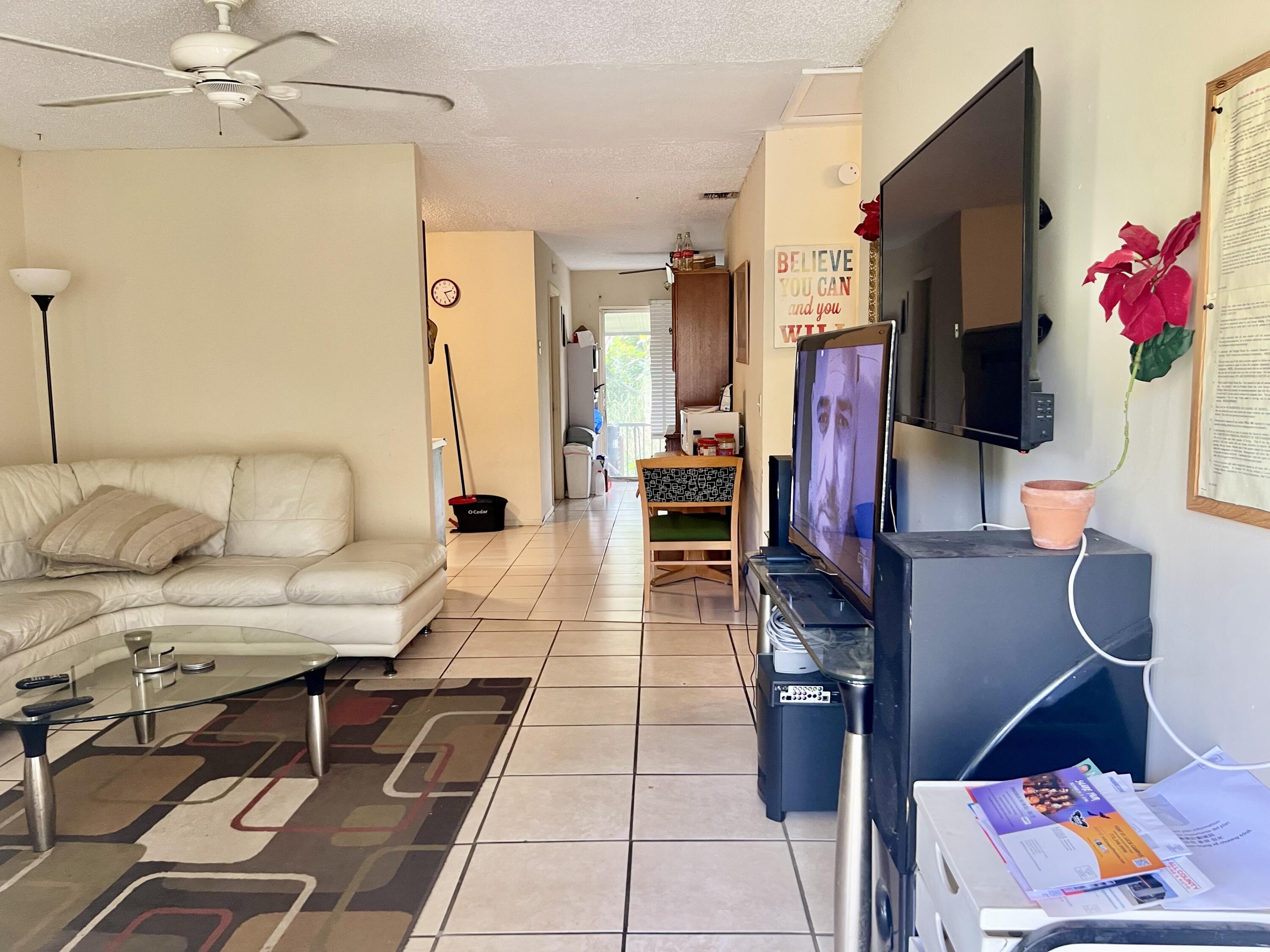 2621 Southeast Clayton Street Stuart, FL 34997 - Photo 14 of 40 a living room with furniture and a flat screen tv