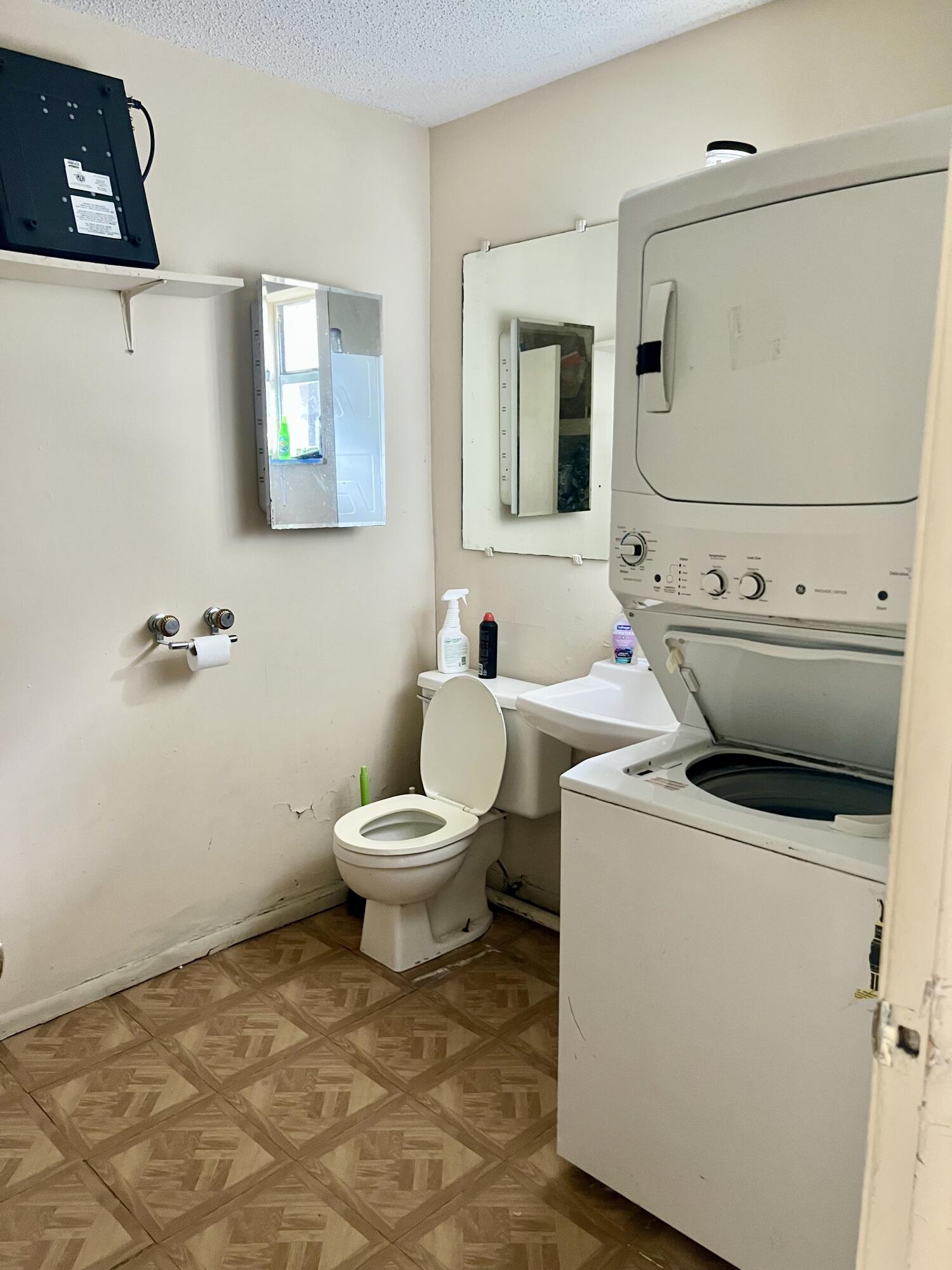 2621 Southeast Clayton Street Stuart, FL 34997 - Photo 16 of 40 a bathroom with a sink toilet and mirror