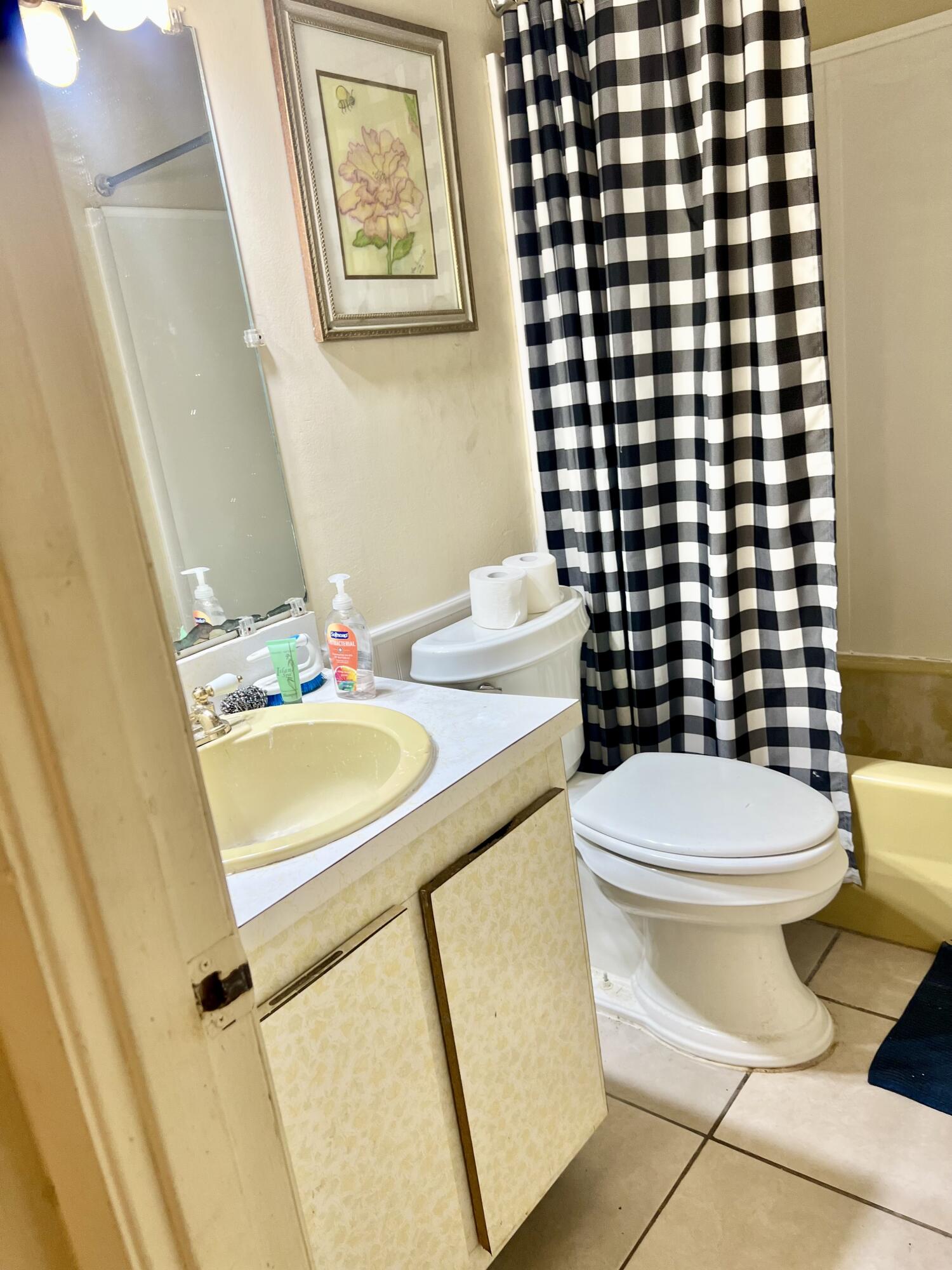 2621 Southeast Clayton Street Stuart, FL 34997 - Photo 18 of 40 a bathroom with a granite countertop sink toilet and shower