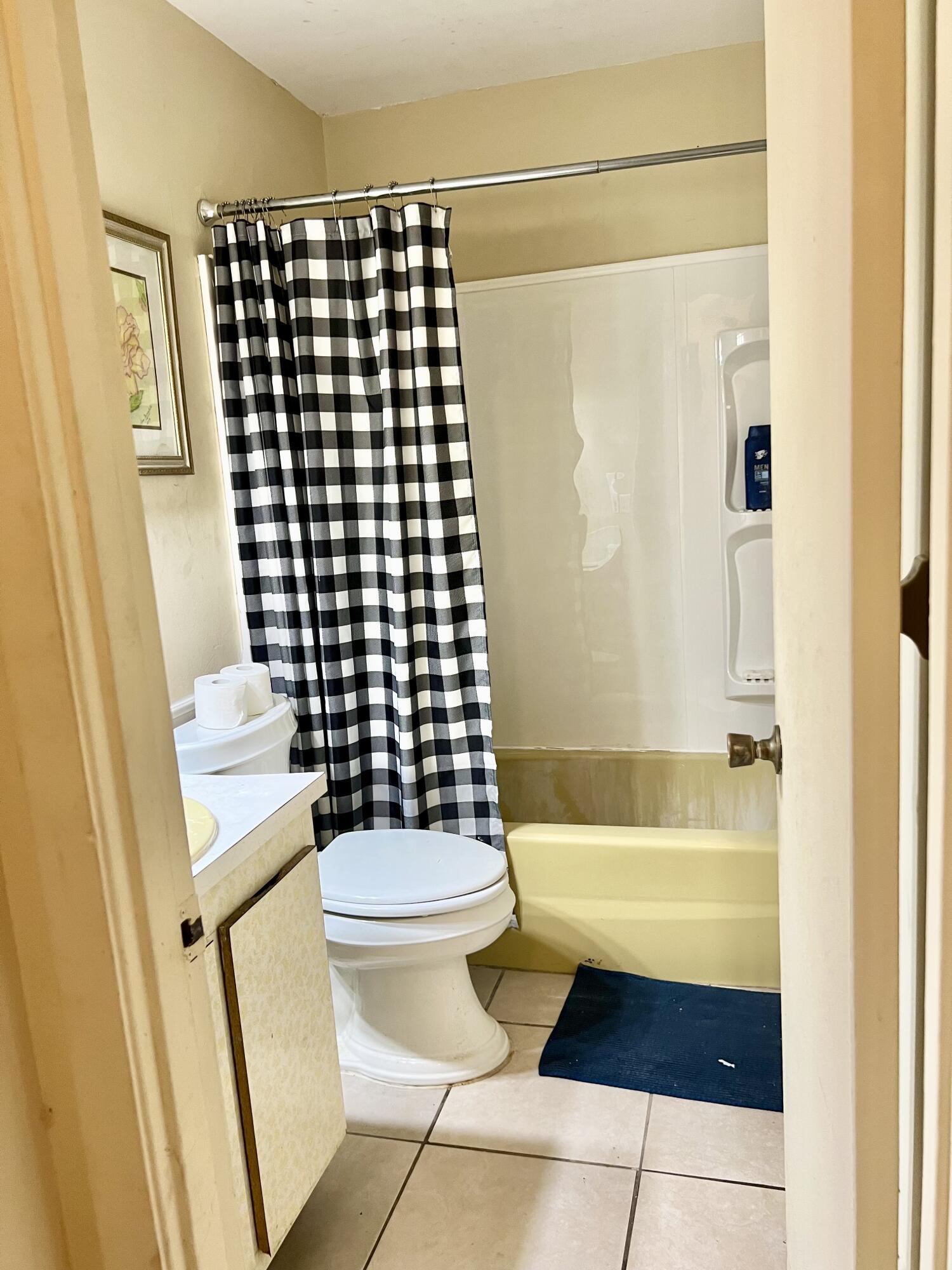 2621 Southeast Clayton Street Stuart, FL 34997 - Photo 19 of 40 a bathroom with a sink a toilet and shower