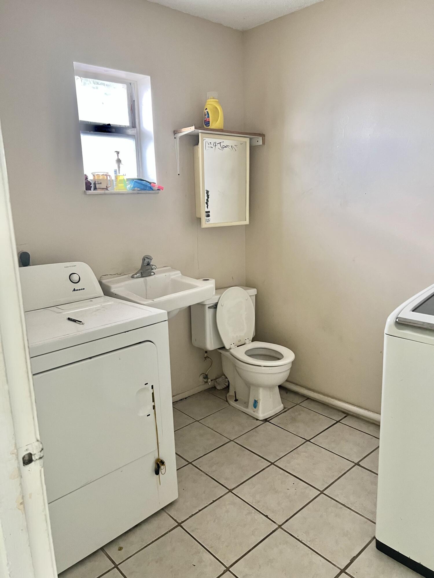 2621 Southeast Clayton Street Stuart, FL 34997 - Photo 22 of 40 a bathroom with a toilet sink and mirror