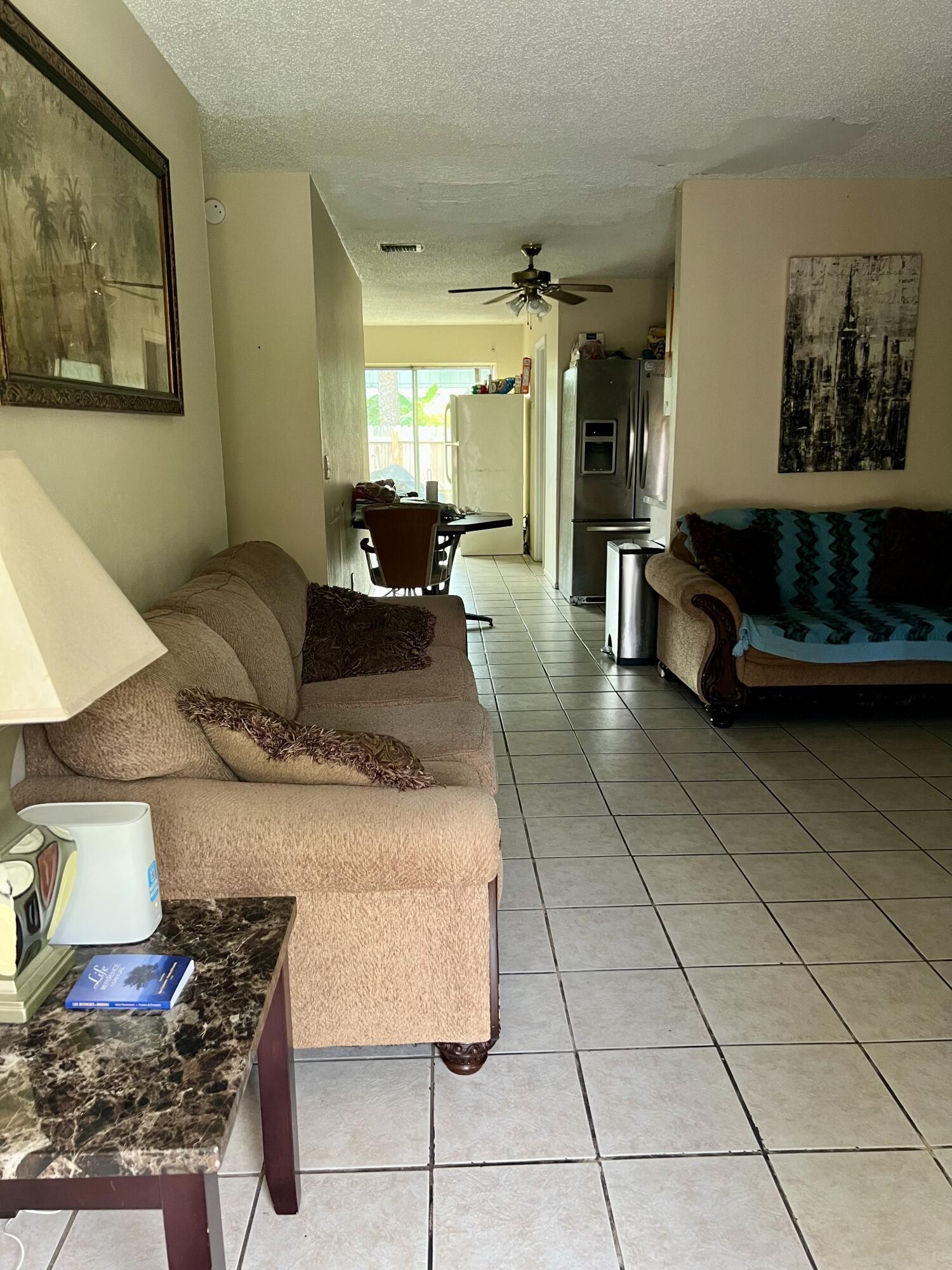2621 Southeast Clayton Street Stuart, FL 34997 - Photo 27 of 40 a living room with furniture and a rug
