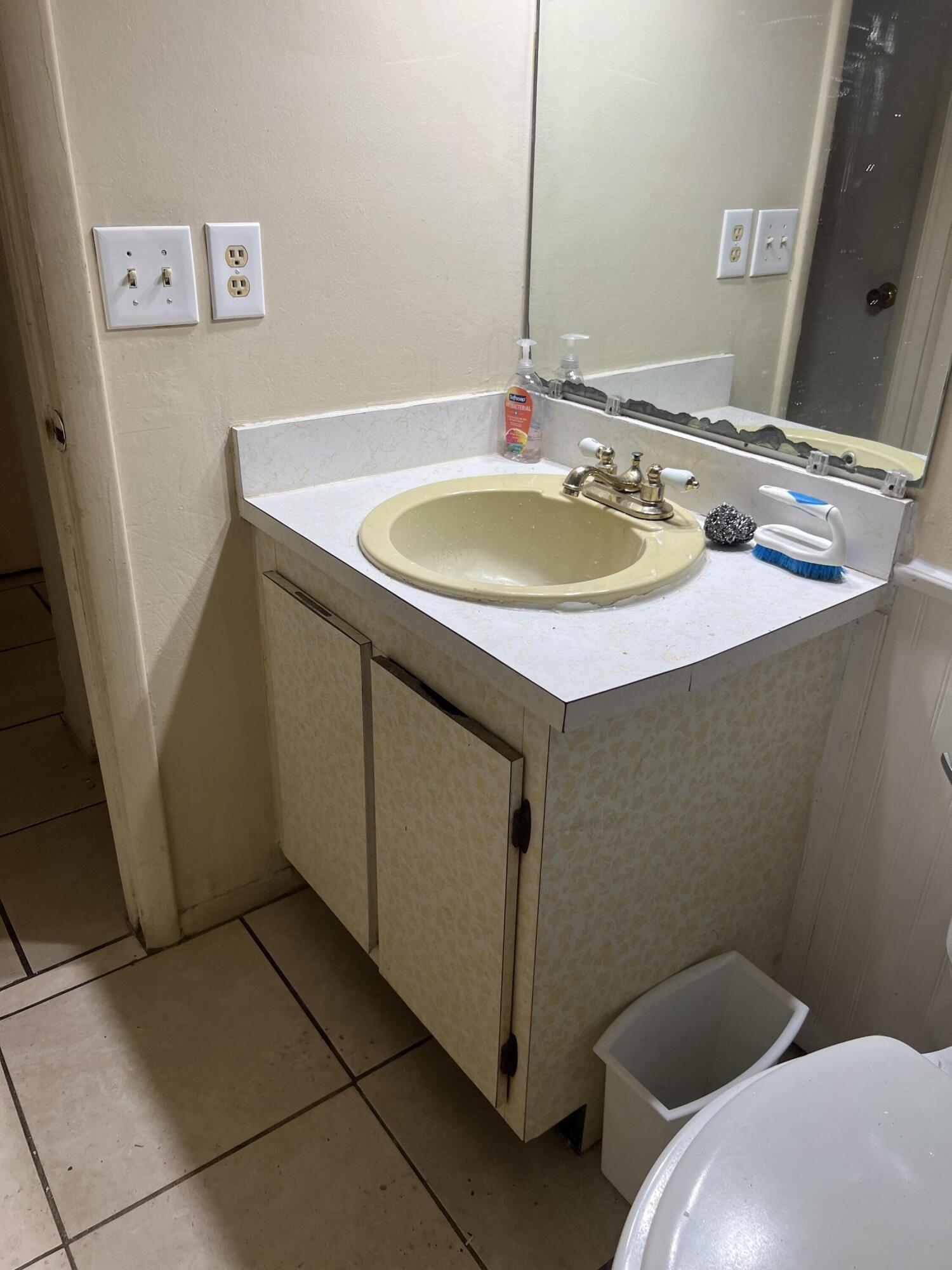 2621 Southeast Clayton Street Stuart, FL 34997 - Photo 29 of 40 a bathroom with a sink and a mirror