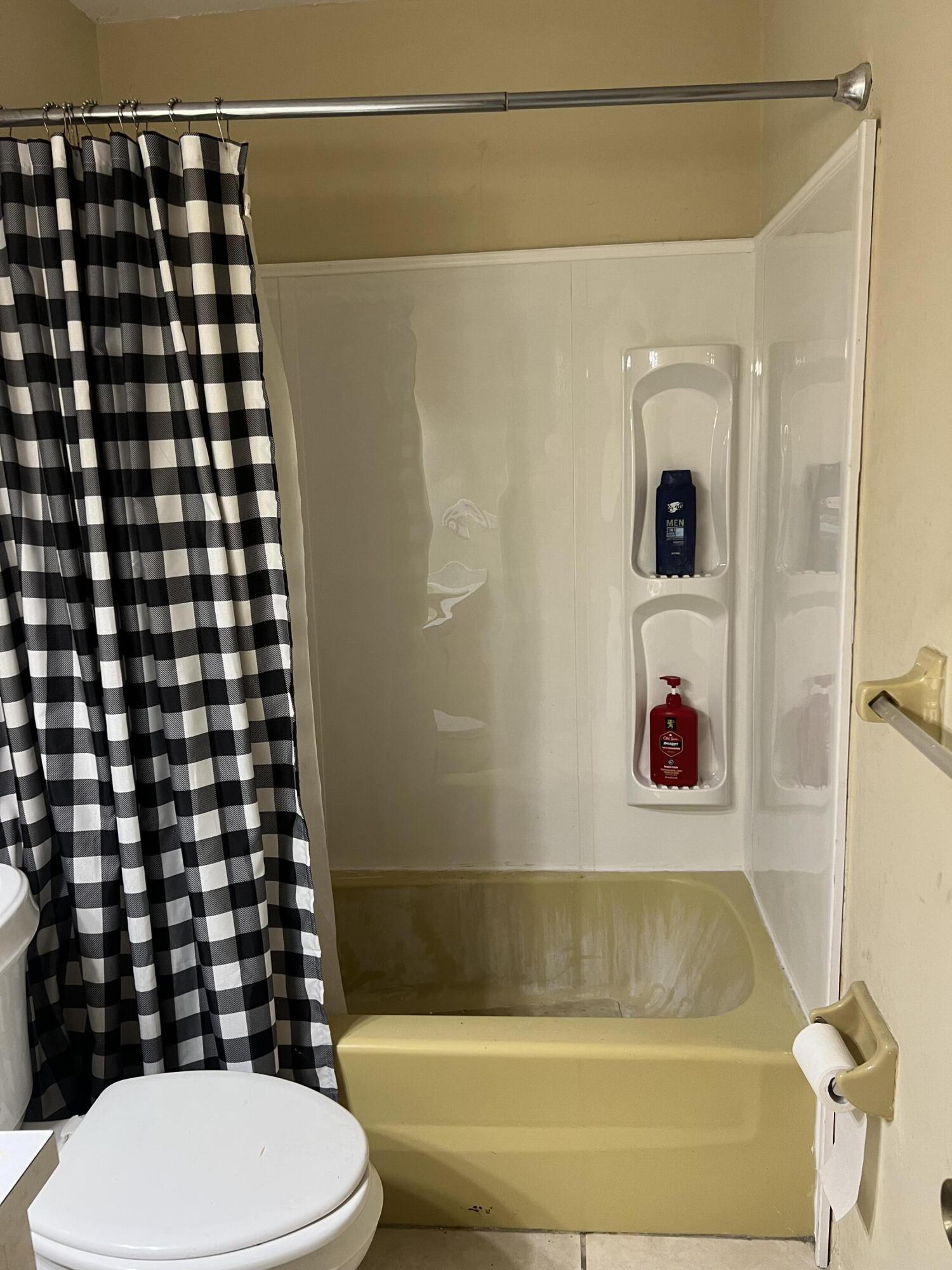 2621 Southeast Clayton Street Stuart, FL 34997 - Photo 30 of 40 a bathroom with a bathtub and shower