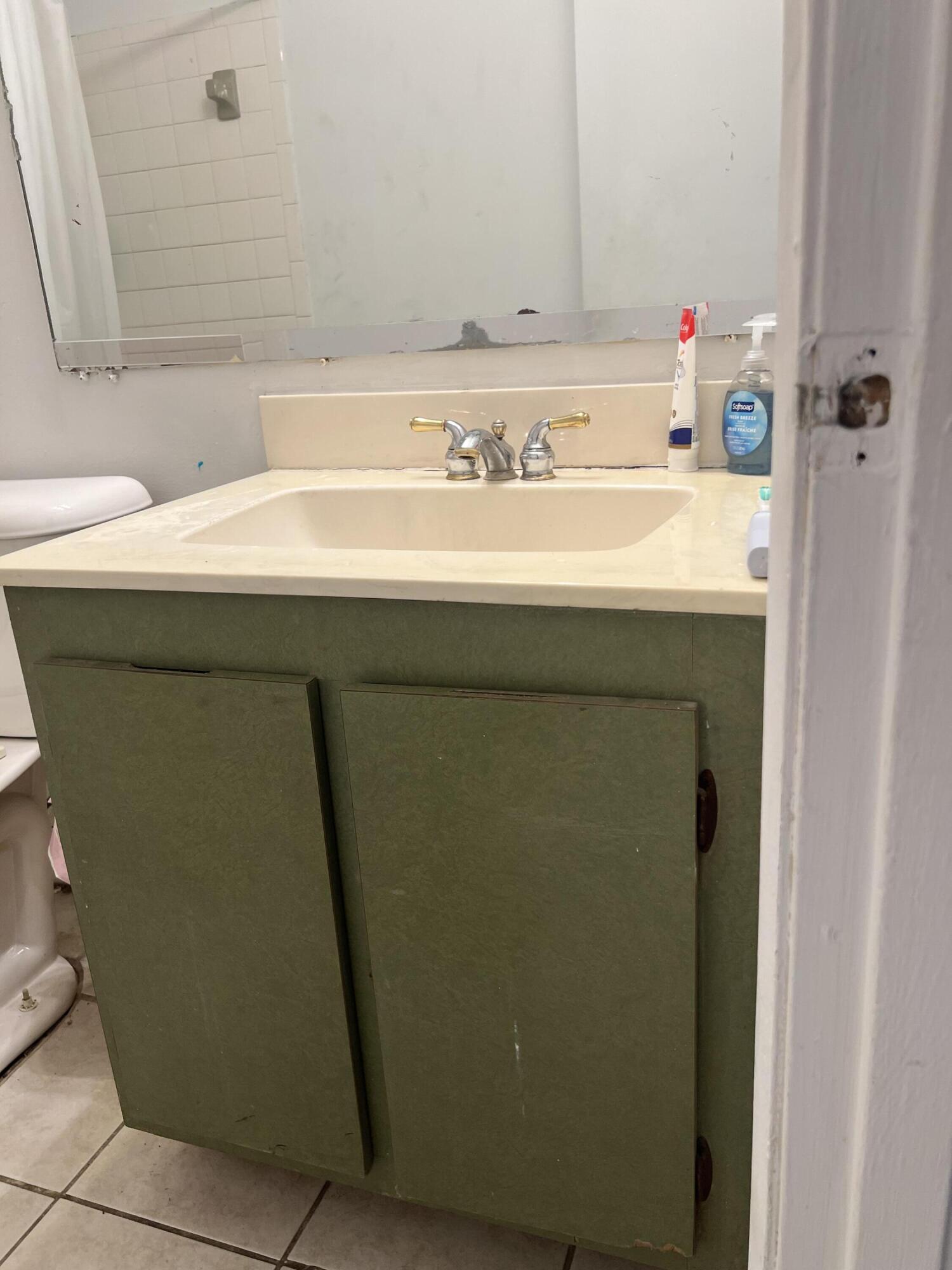 2621 Southeast Clayton Street Stuart, FL 34997 - Photo 31 of 40 a bathroom with a sink and a mirror