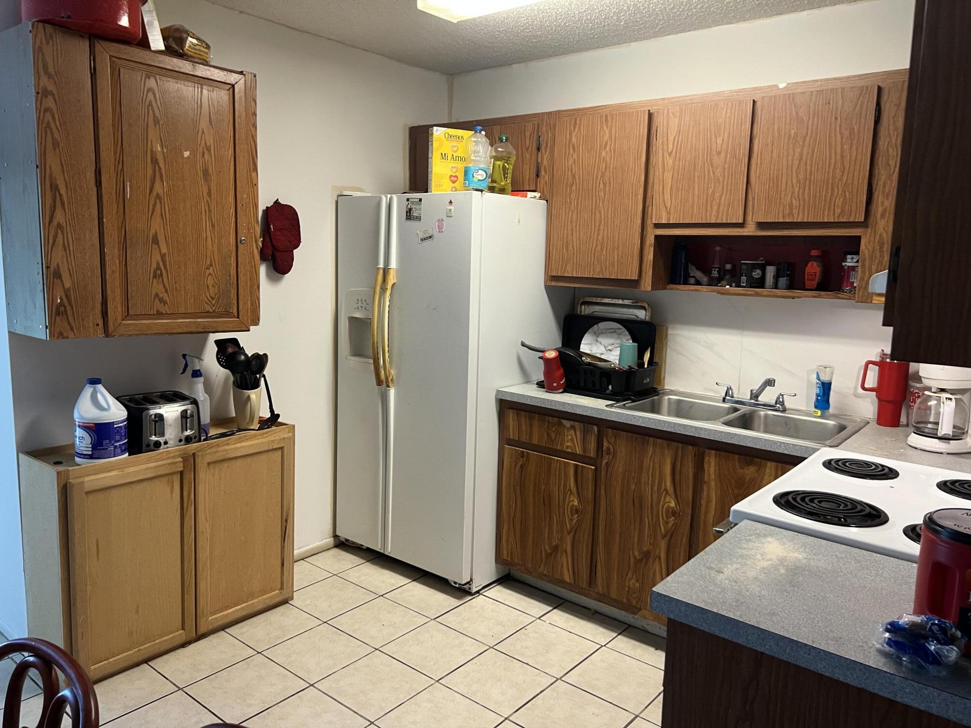 2621 Southeast Clayton Street Stuart, FL 34997 - Photo 33 of 40 a kitchen with a refrigerator and a stove top oven