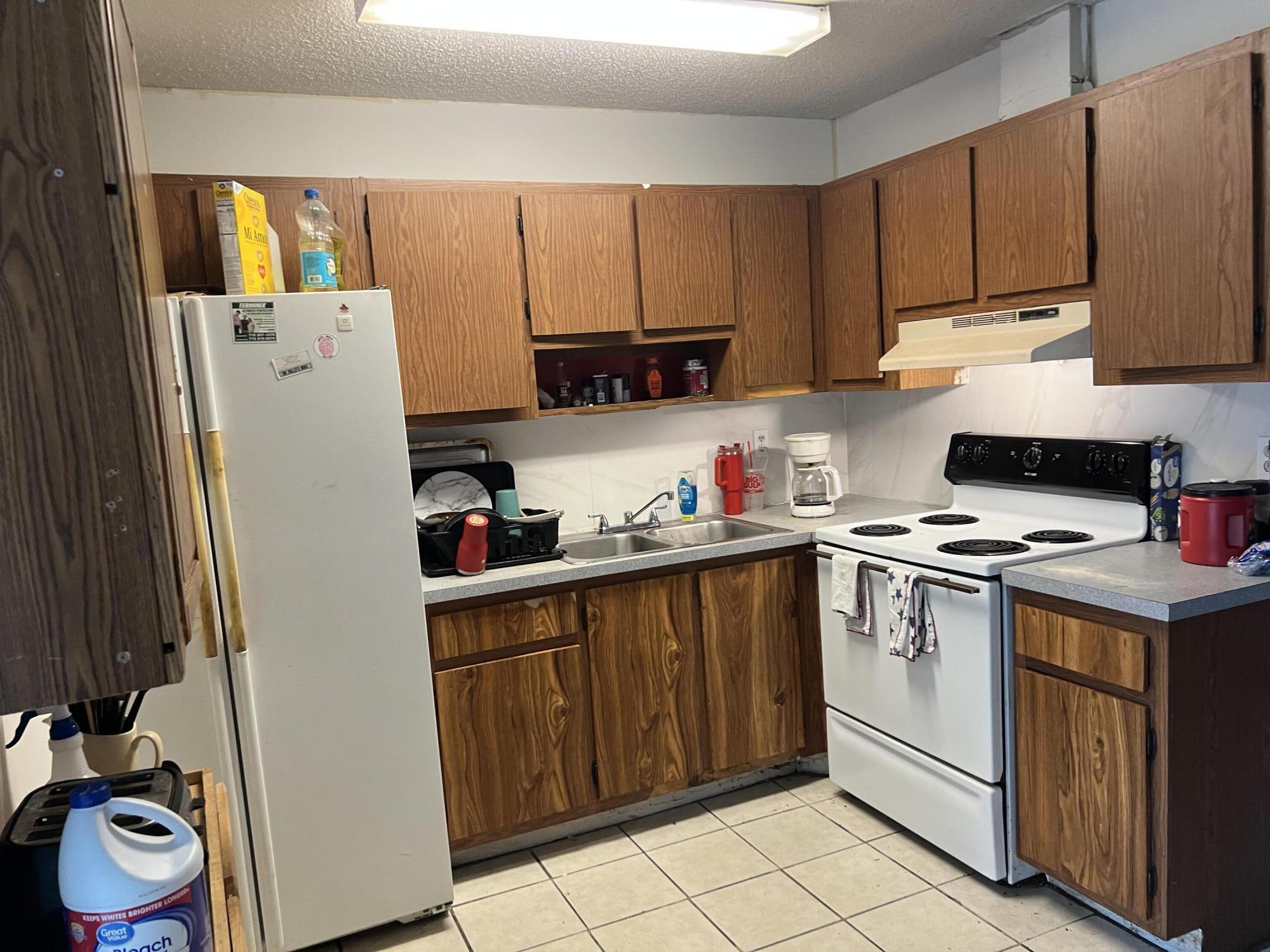 2621 Southeast Clayton Street Stuart, FL 34997 - Photo 34 of 40 a kitchen with a refrigerator and a stove top oven