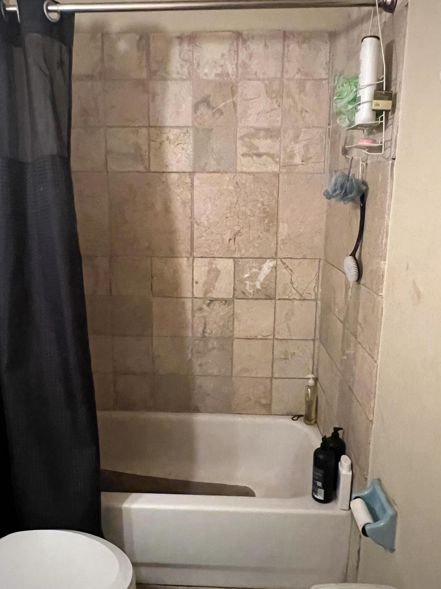 2621 Southeast Clayton Street Stuart, FL 34997 - Photo 38 of 40 a bathroom with a bathtub and shower