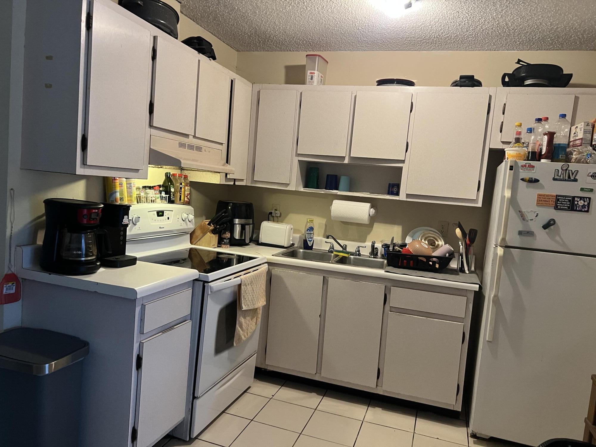 2621 Southeast Clayton Street Stuart, FL 34997 - Photo 40 of 40 a kitchen with a sink a stove and cabinets