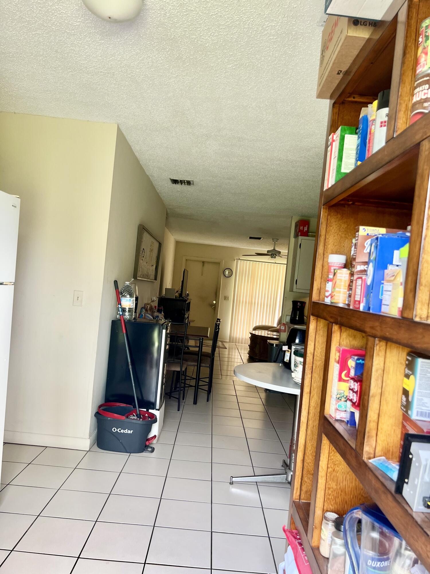 2621 Southeast Clayton Street Stuart, FL 34997 - Photo 7 of 40 a living room with furniture and a floor to ceiling window