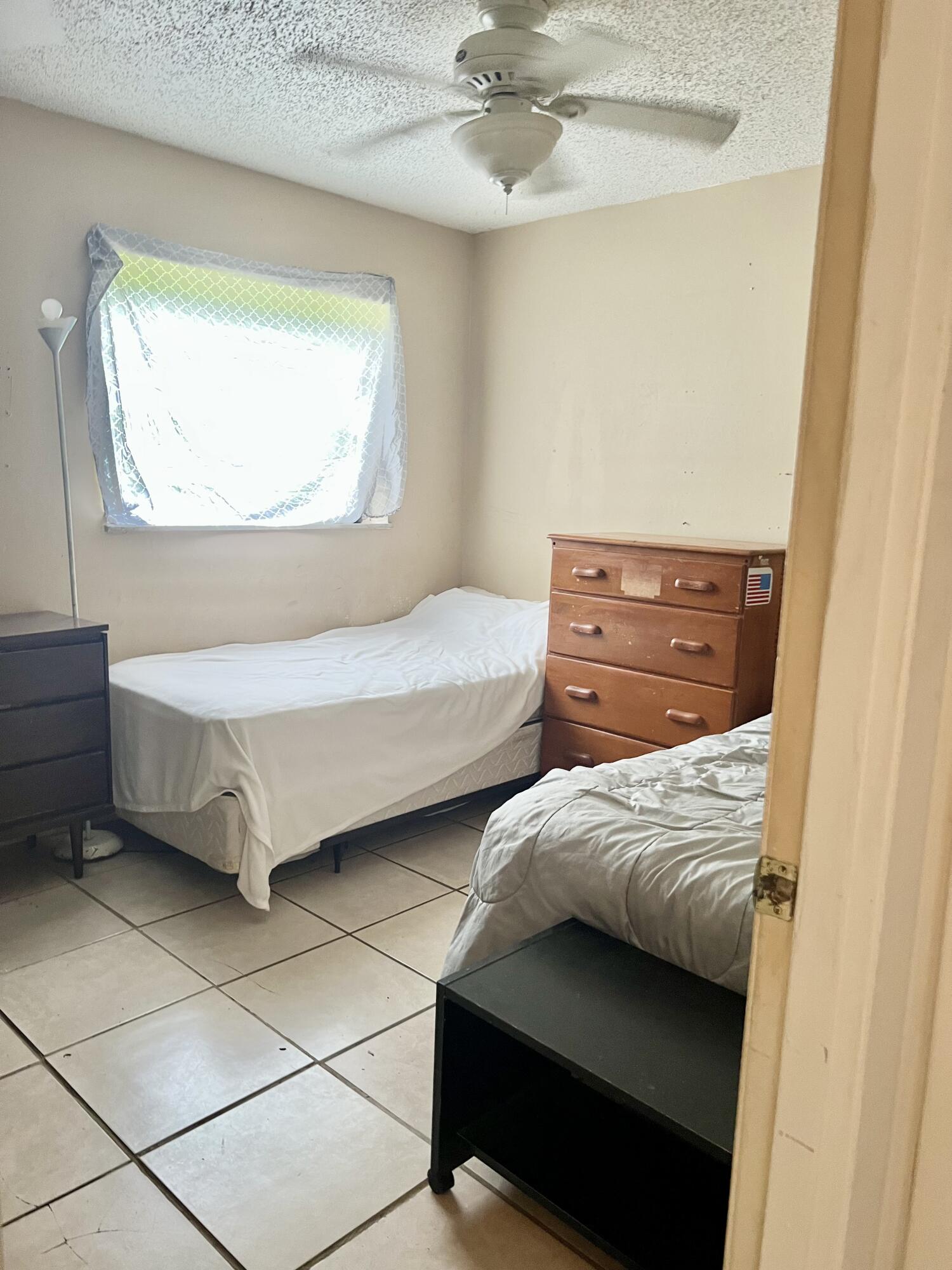 2621 Southeast Clayton Street Stuart, FL 34997 - Photo 9 of 40 a bedroom with a bed and a window