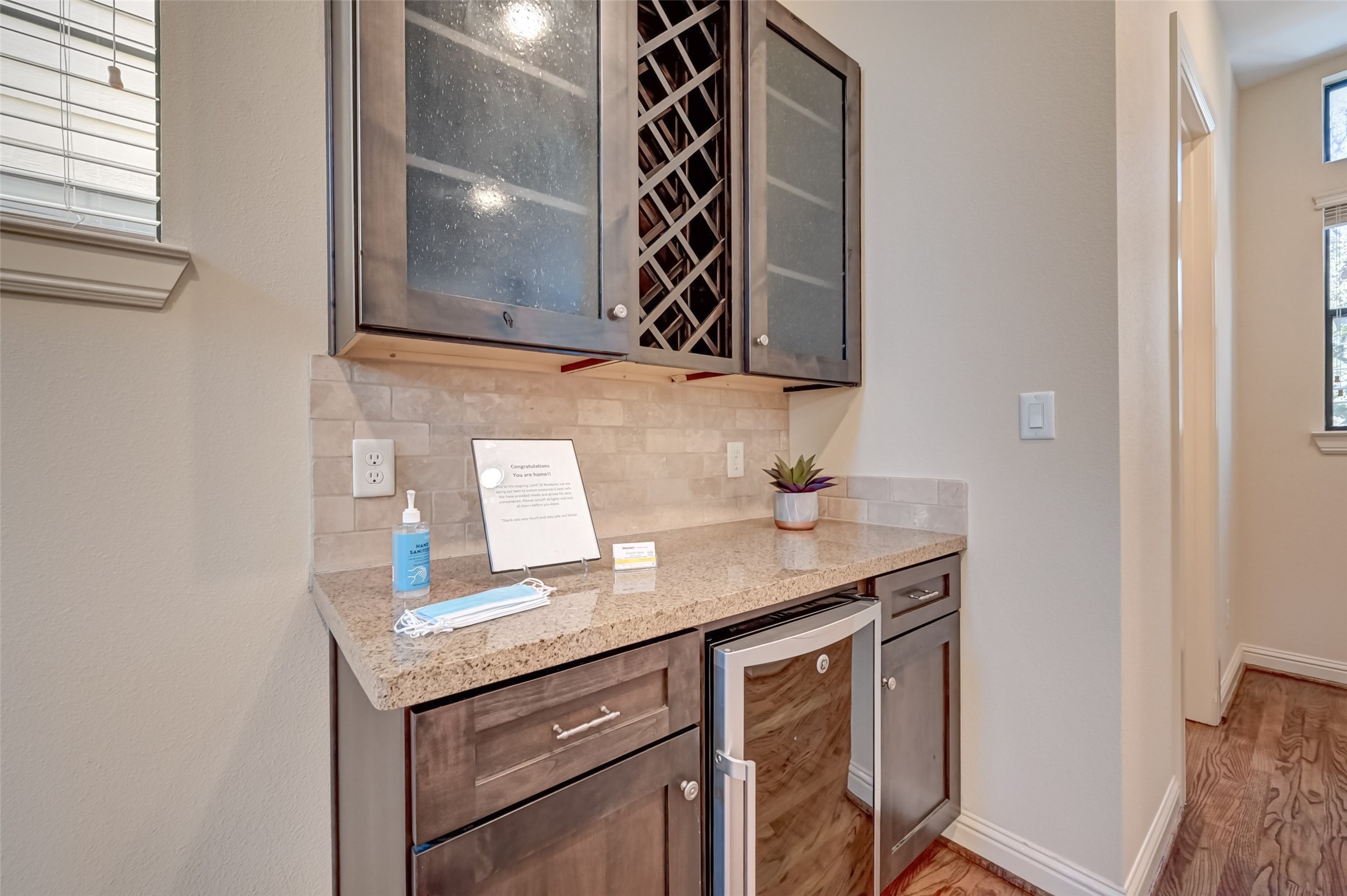 5211 Eigel Street, Unit C Houston, TX 77007 - Photo 10 of 35 Wine bar off of living room features a built in wine rack, granite counters, and wine refrigerator.