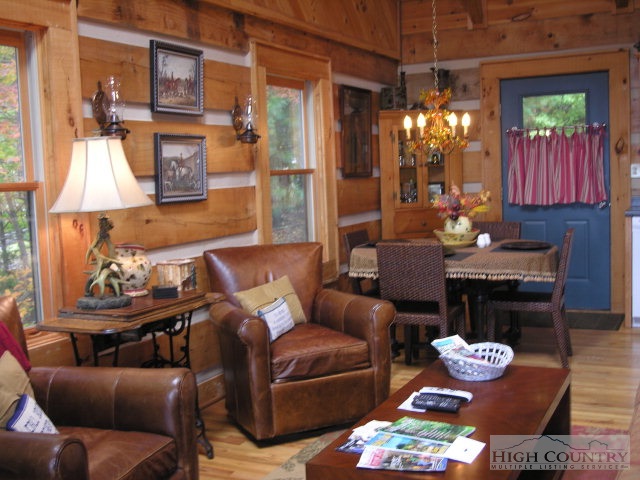 236 Frog Hollar Road Deep Gap, NC 28618 - Photo 12 of 23 a living room with furniture and a chandelier