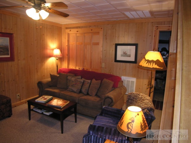 236 Frog Hollar Road Deep Gap, NC 28618 - Photo 15 of 23 a living room with furniture and a lamp