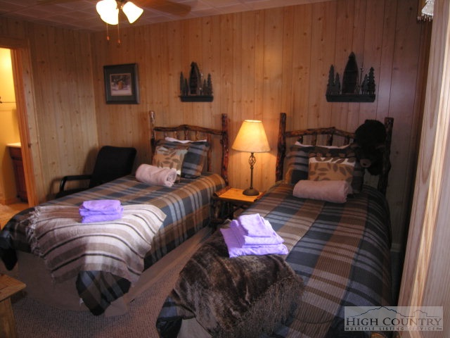 236 Frog Hollar Road Deep Gap, NC 28618 - Photo 16 of 23 a bedroom with a bed and a lamp on dresser