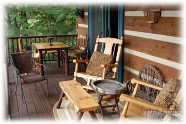 236 Frog Hollar Road Deep Gap, NC 28618 - Photo 20 of 23 a balcony with wooden floor table and chairs