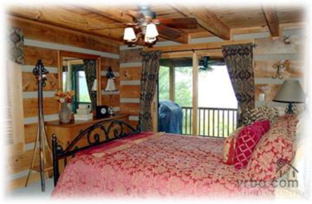 236 Frog Hollar Road Deep Gap, NC 28618 - Photo 22 of 23 a bedroom with a bed and a large window