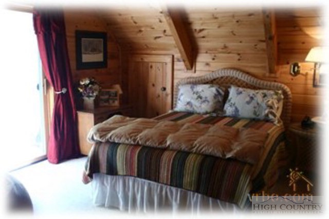 236 Frog Hollar Road Deep Gap, NC 28618 - Photo 23 of 23 a bed sitting in a bedroom next to a window