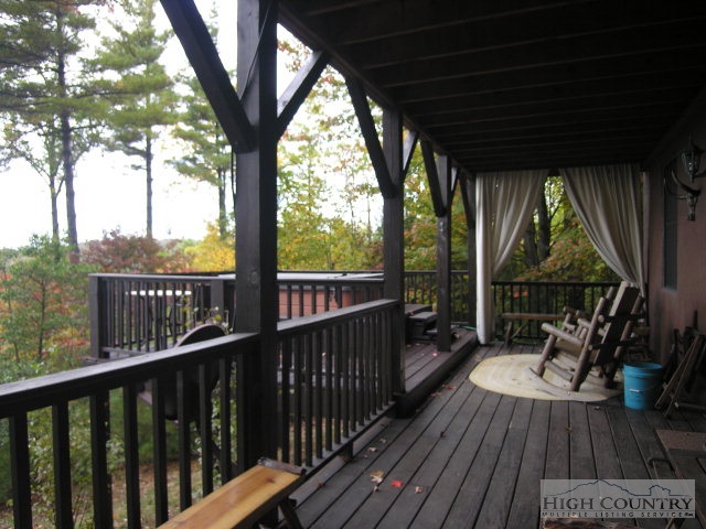 236 Frog Hollar Road Deep Gap, NC 28618 - Photo 4 of 23 a view of a balcony with couch and wooden floor