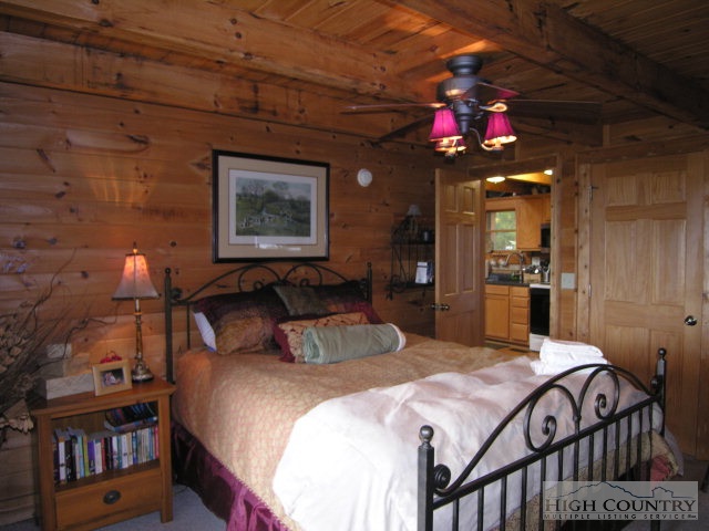 236 Frog Hollar Road Deep Gap, NC 28618 - Photo 6 of 23 a bedroom with bed and wooden floor