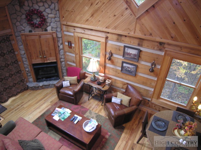 236 Frog Hollar Road Deep Gap, NC 28618 - Photo 10 of 23 a living room with furniture and a floor to ceiling window