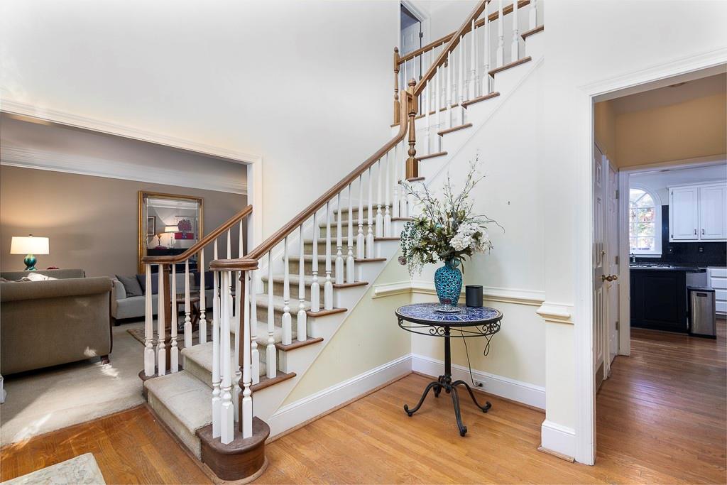 135 Lazy Laurel Chase Roswell, GA 30076 - Photo 11 of 64 a view of entryway with wooden floor and stairs