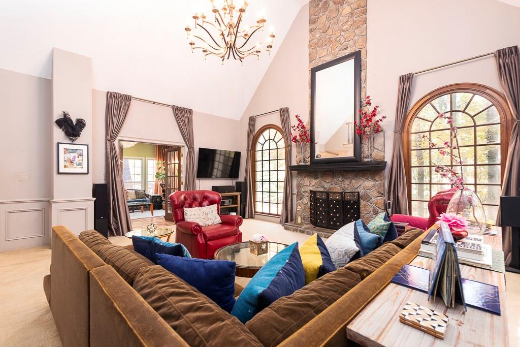 135 Lazy Laurel Chase Roswell, GA 30076 - Photo 32 of 64 a living room with fireplace furniture and a large window