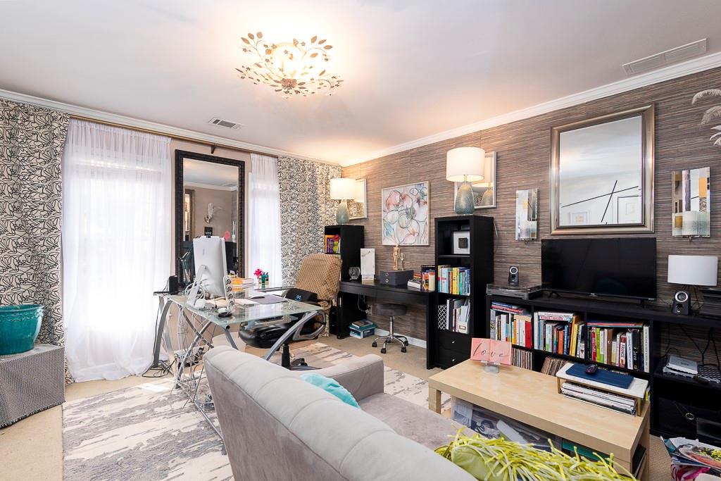 135 Lazy Laurel Chase Roswell, GA 30076 - Photo 34 of 64 a living room with fireplace furniture and a flat screen tv