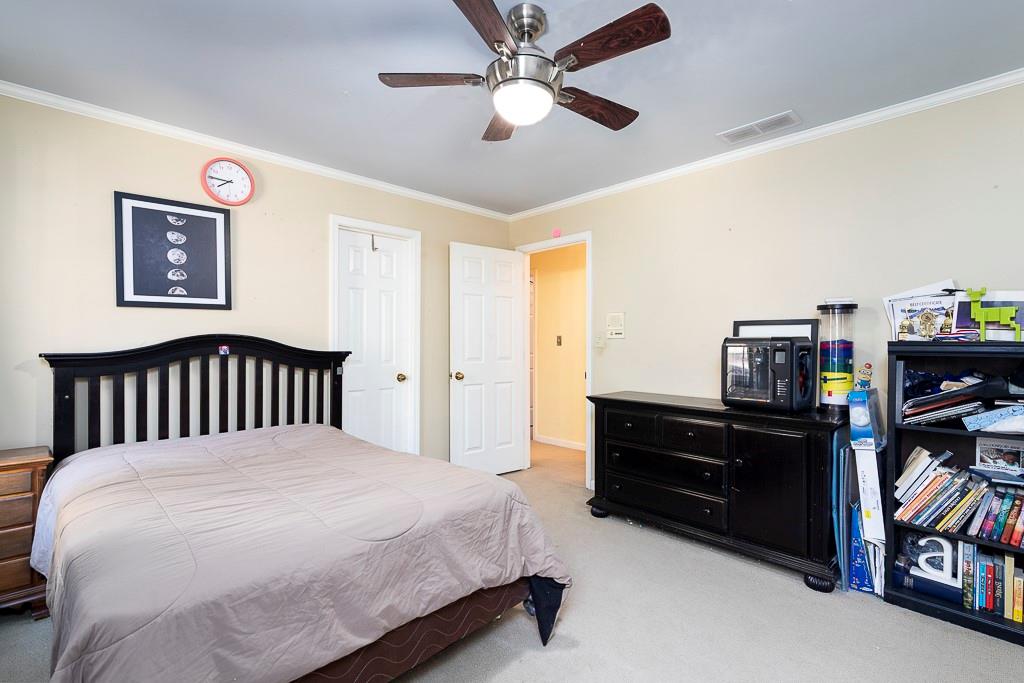 135 Lazy Laurel Chase Roswell, GA 30076 - Photo 39 of 64 a bedroom with a bed and furniture