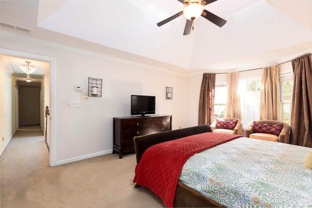 135 Lazy Laurel Chase Roswell, GA 30076 - Photo 41 of 64 a bedroom with a bed and a flat screen tv