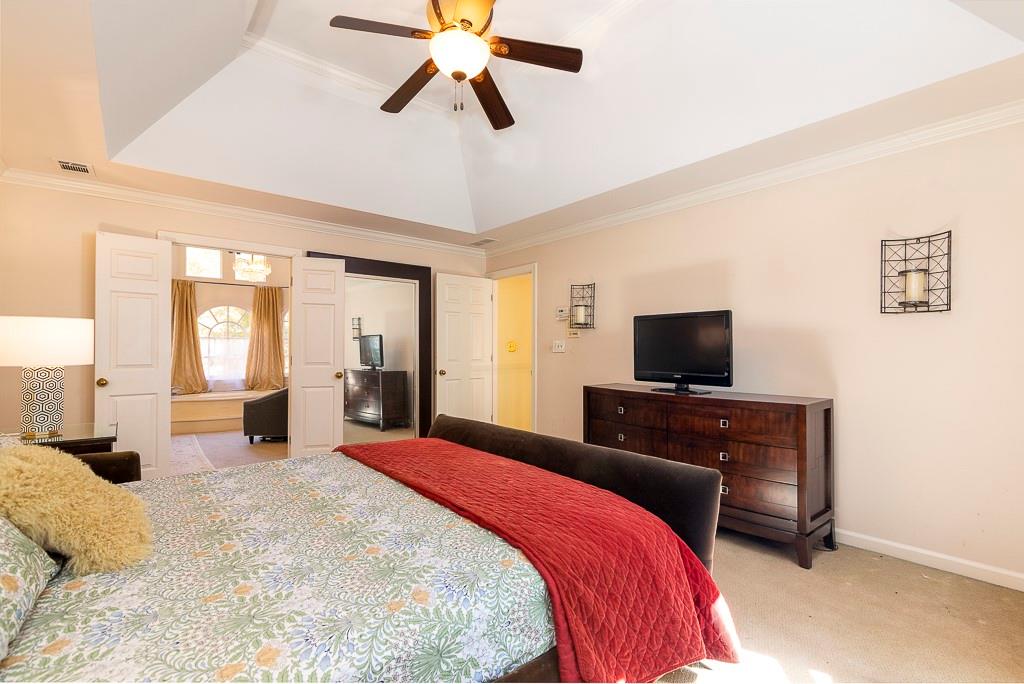 135 Lazy Laurel Chase Roswell, GA 30076 - Photo 42 of 64 a bedroom with a bed and a flat screen tv