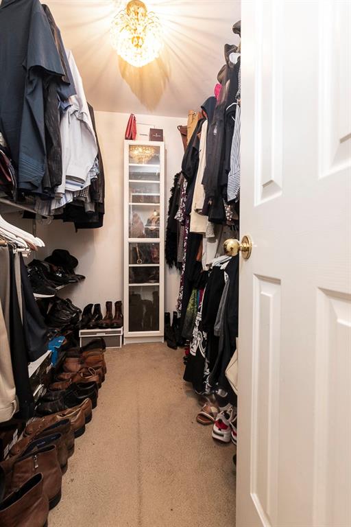 135 Lazy Laurel Chase Roswell, GA 30076 - Photo 45 of 64 a view of walk in closet with clothes and shoes