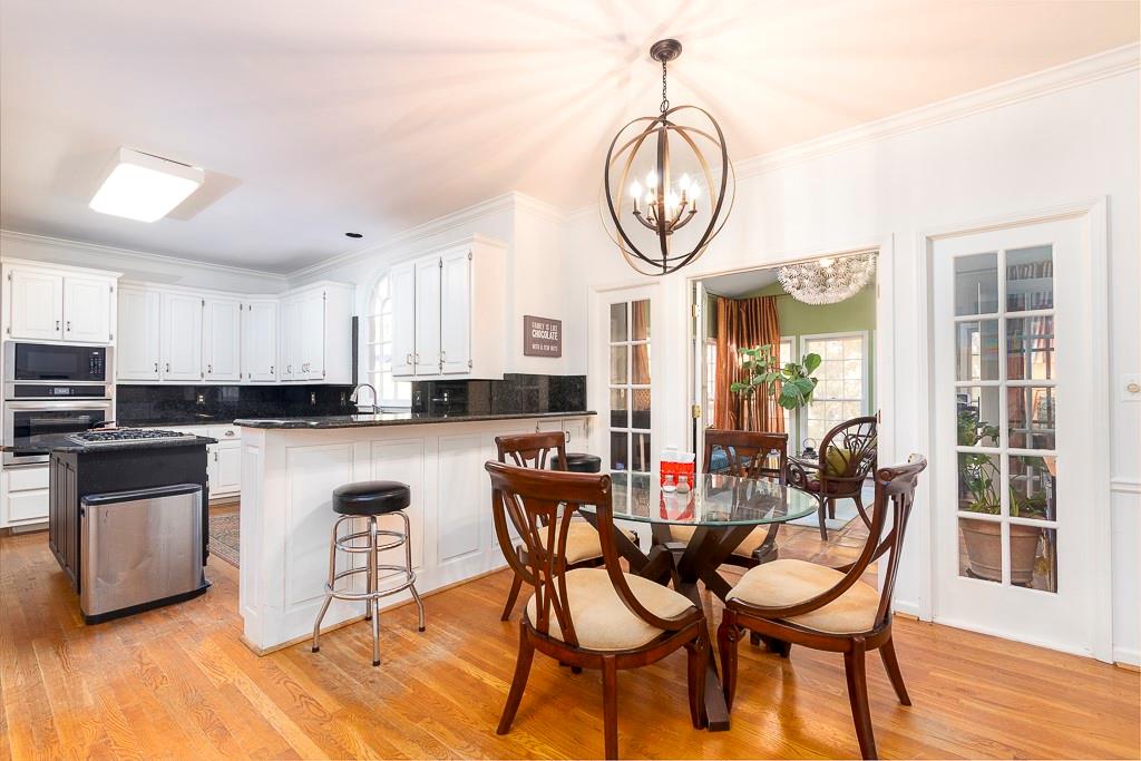 135 Lazy Laurel Chase Roswell, GA 30076 - Photo 5 of 64 a view of a dining room with furniture window and wooden floor