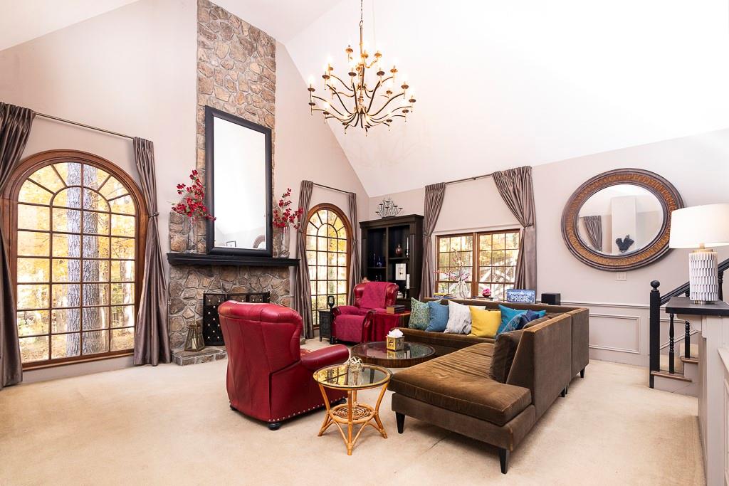 135 Lazy Laurel Chase Roswell, GA 30076 - Photo 6 of 64 a living room with furniture a fireplace and a large window
