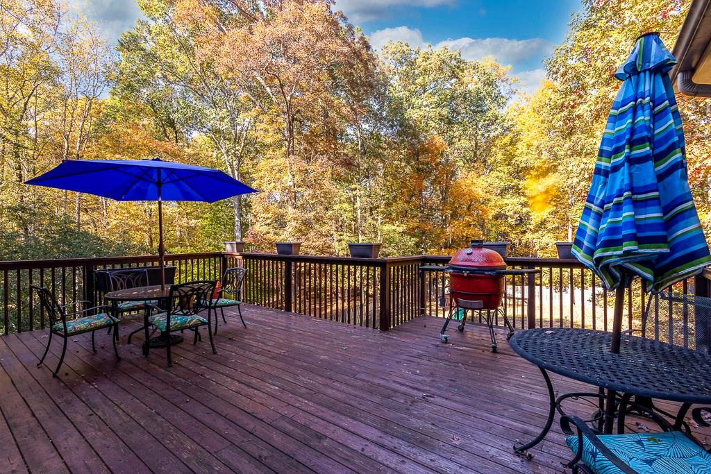 135 Lazy Laurel Chase Roswell, GA 30076 - Photo 10 of 64 a view of a roof deck with chair and wooden floor