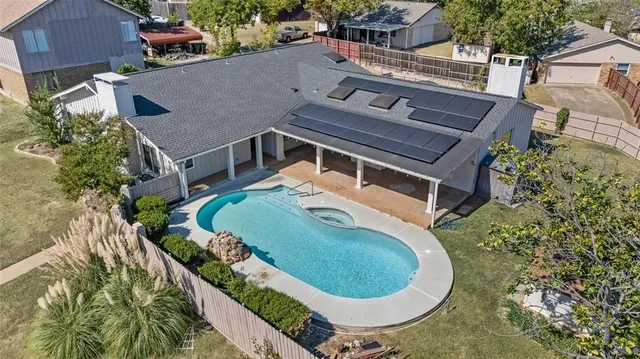 an aerial view of a house with a swimming pool