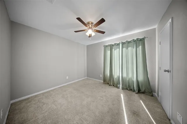 an empty room with closet and windows
