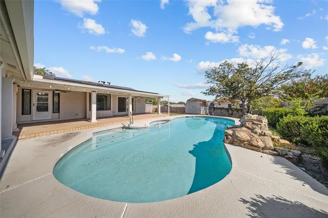 a view of a house with a backyard porch and sitting area